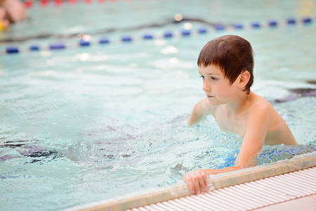 Seven years old boy learning to swim at the pool. Swimming schoolの写真素材