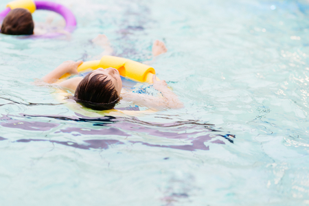 Seven years old boy learning to swim at the pool. Swimming schoolの写真素材
