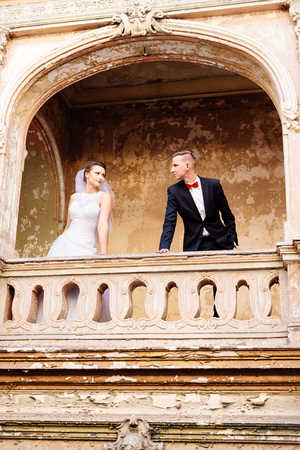 Bride and groom on the balcony in the old castle. Wedding day. Wedding sessionの写真素材