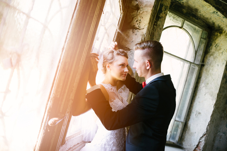 Newlyweds kissing near old door . Wedding day. Wedding sessionの写真素材