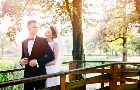 Young beautiful bride and groom kissing and hugging in the park. Wedding day. Wedding sessionの写真素材