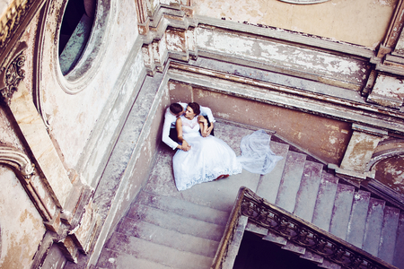 Newlyweds near old stairs . Wedding day. Wedding sessionの写真素材