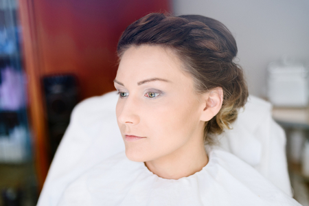 Makeup artist making a wedding makeup for bride. Wedding preparations. Bridal morning of a cute lady. Wedding day.の写真素材