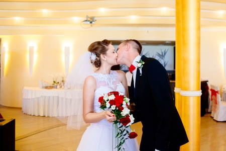 Newlyweds first kiss on wedding party. Wedding day.の写真素材