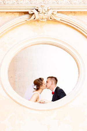 Bride and groom kissing in the old palace. Wedding day. Wedding sessionの写真素材
