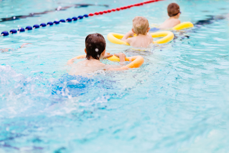 Seven years old boy learning to swim at the pool. Swimming schoolの写真素材