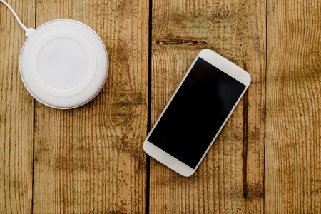 White smartphone and charging pad. Wireless chargingの写真素材