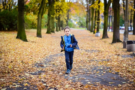 Happy little boy running in the parkの写真素材
