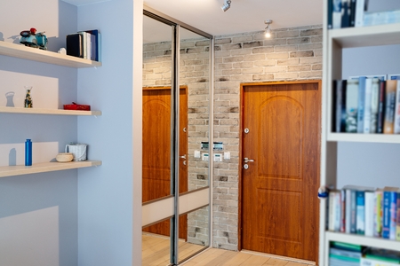 Entrance hall in modern apartment with mirror wardrobe with sliding doorsの写真素材
