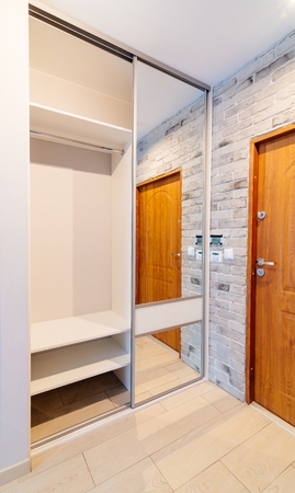 Entrance hall in modern apartment with mirror wardrobe with sliding doorsの写真素材