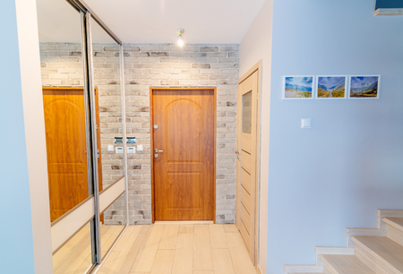 Entrance hall in modern apartment with mirror wardrobe with sliding doorsの写真素材