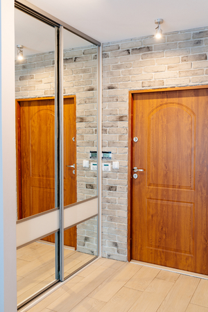 Entrance hall in modern apartment with mirror wardrobe with sliding doorsの写真素材