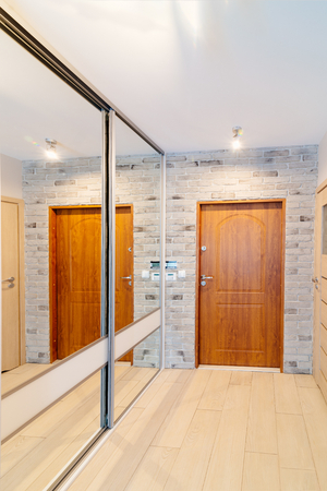 Entrance hall in modern apartment with mirror wardrobe with sliding doorsの写真素材