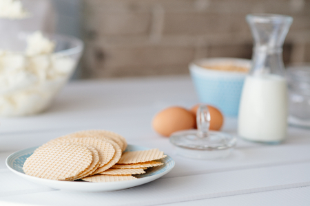 Delicious sweet waffles on plate with milk and eggsの写真素材