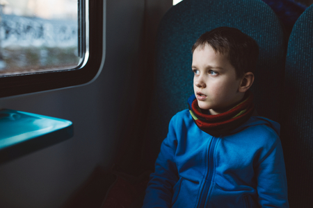 Little child boy travelling alone with with trainの写真素材