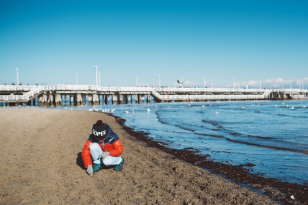 Little boy child on the beach. Winter seaの写真素材