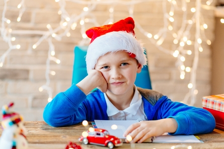 Happy child in Santa Claus cap at Christmas. Merry Christmasの写真素材