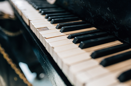 Old damaged piano keyboard. Black and white keysの写真素材