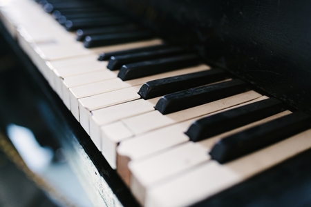 Old damaged piano keyboard. Black and white keysの写真素材