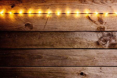 Old wooden rustic Christmas background with star shaped lights.の写真素材