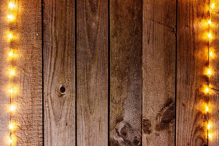 Old wooden rustic Christmas background with star shaped lights.の写真素材
