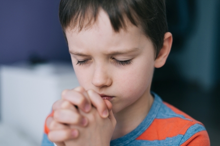 Little boy praying. Boy's prayer. Gesture of faith. More from this series in my portfolioの写真素材
