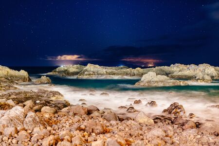 Beautiful night view on ocean and rocks. Starry night. Los Gigantes, Puerto de Santiago, Tenerife,...