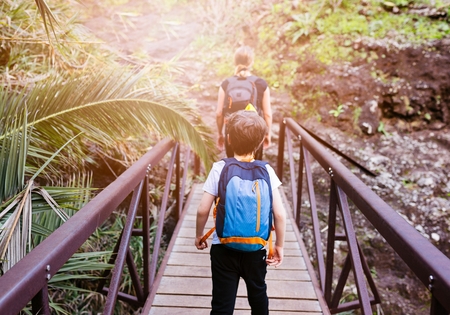 Little boy child crossing little bridge in mountains. Mountain adventure. Masca Valley, Tenerife island, Canary Islands, Spainの写真素材