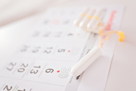 Woman hygiene protection, menstruation calendar and clean cotton tampons. Marked menstruation daysの写真素材