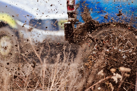 Wreck scrap cars dirt race. Selective focus on splashing mudの写真素材