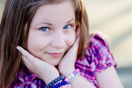 Portrait of happy blond hair ten years old blue eyed girlの写真素材