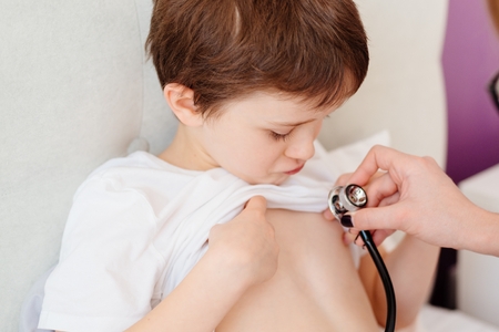 Little boy child is examining by a doctor with stethoscope. Sick childの写真素材