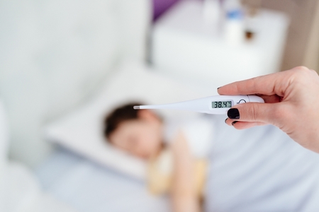 Baby digital thermometer to measure the heat temperature of a sick child. Kid's clinic.の写真素材