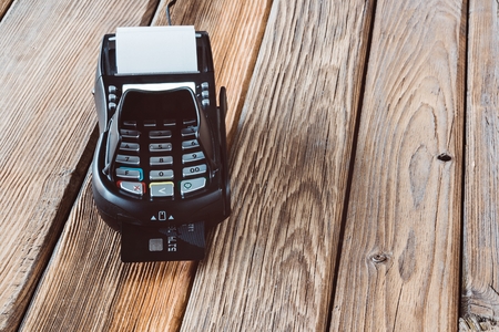 Payment with credit card terminal. Wooden backgroundの写真素材