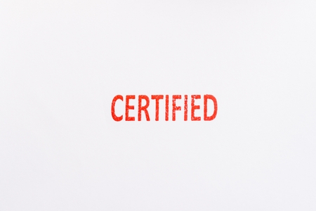 Red certified rubber stamp on white sheet of paper. Law office.の写真素材
