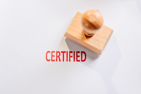 Red certified rubber stamp on white sheet of paper. Law office.の写真素材