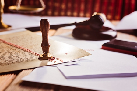 Metal wax notary public stamper on old document. Law officeの写真素材