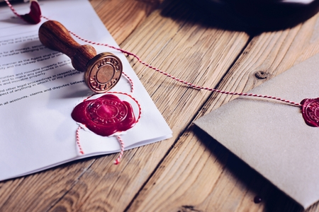 Notary public wax stamper and wax seal on documentの写真素材