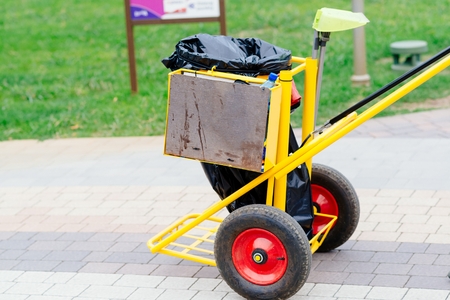 Yellow cleaning service trolley in amusement park