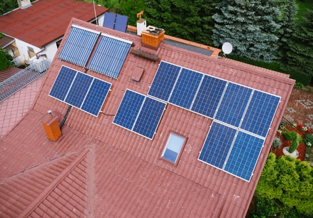 Aerial view of photovoltaic solar panels on house roofの写真素材