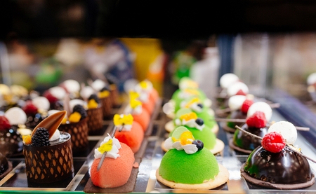 Delicious cakes on display in a confectionery shopの写真素材