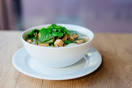 Fresh vietnamese pho soup in dish on wooden tableの写真素材