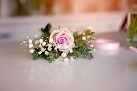 Beautiful pink rose on white wooden tableの写真素材