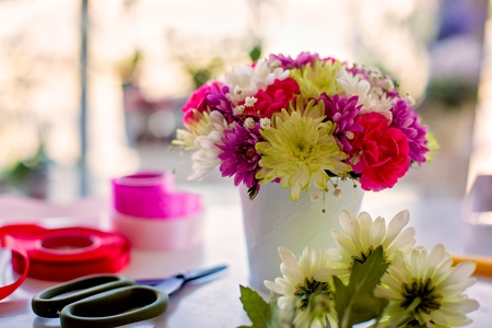 Beautiful bouquet of colorful gerbera daisies flowers in white potの写真素材