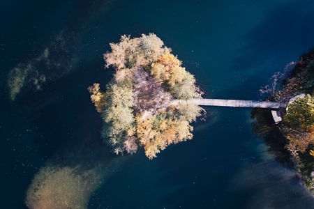 Small island in the middle of the lake. Autumn at the lakeの写真素材
