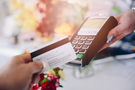 Man paying for flowers with his debit card. Credit card paymentの写真素材