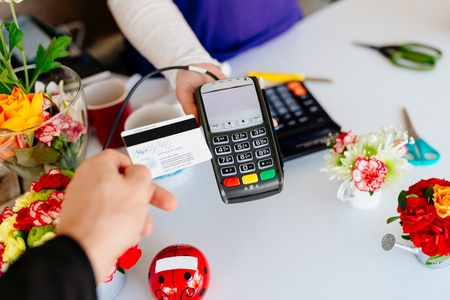 Man paying for flowers with his debit card. Credit card paymentの写真素材