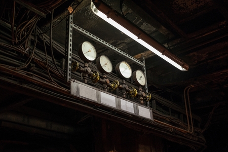 Old rusty manometers and valves in an old power plantの写真素材