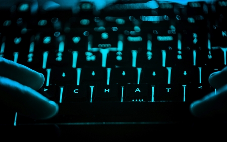 Chat - text on illuminated computer keyboard at night. Internet search conceptの写真素材