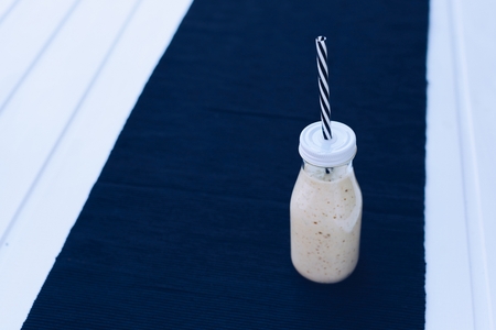 Delicious pear yogurt cocktail in bottle with strawの写真素材